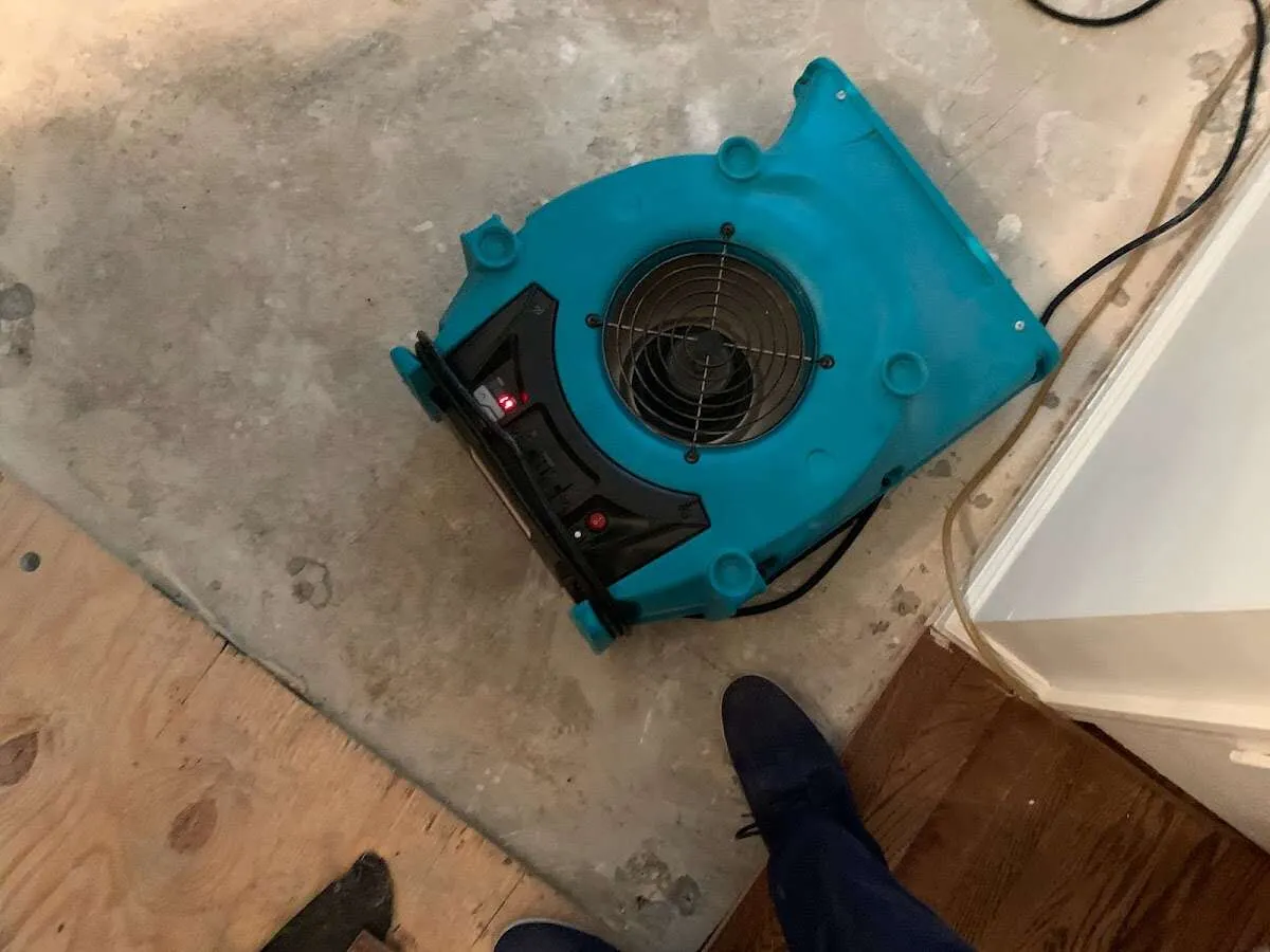 Air mover drying subfloor during Commercial Water Damage Restoration in Saratoga Springs